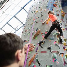 a man climbing up the side of a rock wall