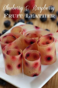 blueberry and raspberry fruit leathers on a white plate