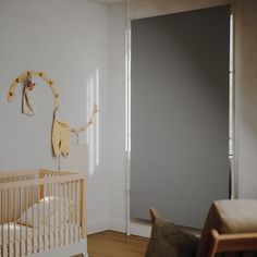 a baby's room with a crib, rocking chair and door