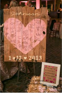 a wooden sign that has been decorated with writing on it and a photo frame next to it