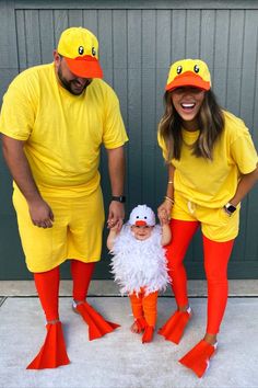 two people dressed in yellow and orange standing next to each other