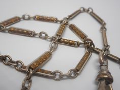 Offered is a wonderful 12 inch pocket watch chain fob. The chain has detailed gold links surrounded by silver outline. This can be worn with both a gold and silver pocket watch and looks amazing! Please note that we only sell original antiques. We do not alter, replace, repair, or re-purpose; and we do not sell reproductions. Buy with confidence that you are receiving the real thing! Please also note that we do not polish the jewelry because many of our customers prefer their jewelry with patina Vintage Silver Pocket Watch With Chain, Gold Metal Pocket Watch With Chain, Silver Pocket Watch, 19th Century Style, Vintage Pocket Watch, Pocket Watch Chain, Gilded Age, Watch Chain, Chain Extenders