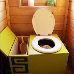 a toilet that is in a small room with wooden walls and flooring, it has the lid open