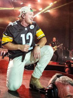 a man kneeling down on top of a stage