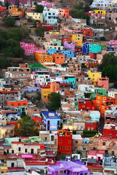 a city with lots of colorful buildings and trees in the background that says, i do not