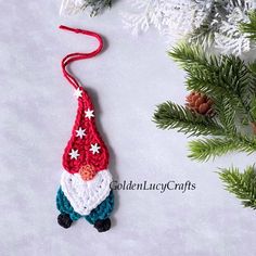 a crocheted christmas ornament hanging from a tree