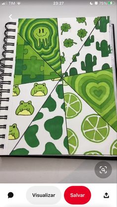 a spiral notebook with green and white designs on it