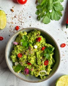 a bowl filled with guacamole and garnished with cilantro