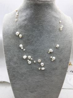 "quantity: 1 strand pearl jewelry:  floating pearl necklace pearl body: please look at picture necklace length: 17.5 inches pearl grade:AA pearl luster:high pearl shape: nugget pearl color: white ---All style of illusion necklace--- https://www.etsy.com/hk-en/shop/WenPearls?ref=hdr_shop_menu&search_query=NPN3 Back to Other Jewelry Section 01: \"Tahitian,Akoya,Sea Pearl\" Section: https://www.etsy.com/shop/WenPearls?section_id=15806339 02: \"Potato/Near Round Pearl\" Section: https://www.etsy.com White Double Strand Pearl Layered Necklace, White Pearl Double Strand Layered Necklace, White Pearl Chain Layered Necklace For Wedding, White Double Strand Pearl Necklace For Party, Leather Pearl Jewelry, Illusion Necklace, Floating Pearl Necklace, Leather Pearl Necklace, Picture Necklace