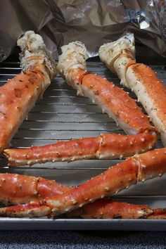 cooked crab legs on a grill with aluminum foil