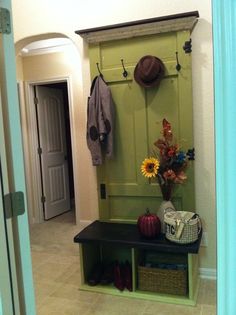 the entryway is decorated with sunflowers, boots and a coat hanger