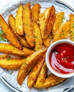 baked french fries with ketchup on a white plate, ready to be eaten