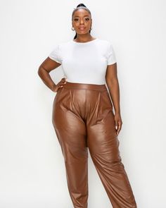 With a slightly pleated front, these sophisticated pull-on faux leather pants are a year round pleasure. Wear them in the summer with a tee, a blazer in the fall, and a sweater in the winter. Wear them for work, weekend and whenever these plus-size pants have large front pockets and a sleek style. L I V D Elise Vegan Leather Pocket Pants | Camel | Pants | Materials & Care Instructions: ['95% Polyester, 5% Spandex', 'Machine wash cold', 'Made in USA'] Vegan Leather Pants, Tapered Joggers, Plus Size Boutique, Leather Pant, Leather Pocket, Plus Size Pants, Straight Trousers, Faux Leather Pants, Sleek Fashion