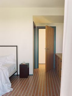 a bed sitting in a bedroom next to a doorway