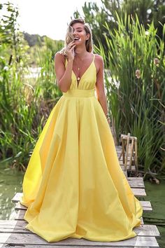 Yellow Ball Gown For Evening, Yellow Evening Dress For Prom Season Party, Yellow Evening Dress For Party During Prom Season, Elegant Yellow Maxi Dress For Prom Season, Yellow Backless Maxi Dress For Evening, Yellow Sleeveless Gown For Prom Season, Yellow Prom Season Party Gown, Yellow V-neck Party Gown, Yellow Satin Party Gown