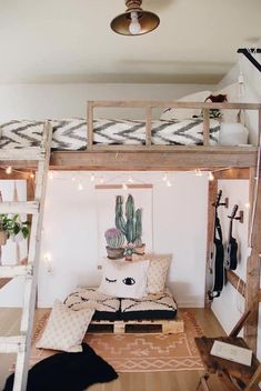 a loft bed with a couch underneath it and lights strung from the ceiling above them