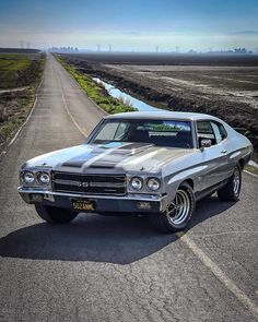 an old car is parked on the side of the road