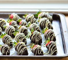 chocolate covered strawberries are arranged on a baking sheet