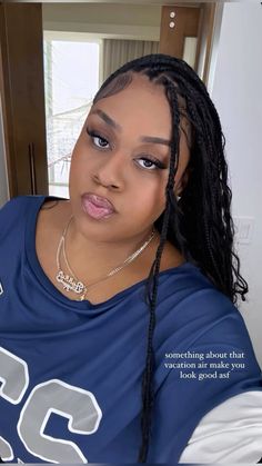 a woman with braids in a blue shirt