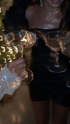 two women holding up wine glasses in their hands