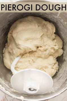 a bowl filled with dough sitting on top of a counter