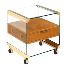 a wooden and glass box on wheels with two drawers underneath the lid, one drawer is open