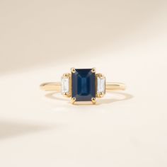 Lauryn Chic, timeless, and versatile - we can’t recommend our rings enough! The Sapphire Stone is the birthstone for September and is associated with nobility, purity, and passion. The Octagon shape of the stone also gives this ring an elegant look. This dainty piece would make the perfect gift for her! - Handmade- Solid Gold- Natural Diamonds and Sapphire - G Color, SI Quality Diamonds- Band Width: 1.7 mm- Total Diamond Carat Weight: .24 ctw- Total Blue Sapphire Carat Weight: 1.14 ctw All piece Saphire Engament Ring Modern, Gold And Sapphire Engagement Ring, Rectangle Sapphire Ring, Blue Sapphire Gold Ring, Solitaire Sapphire Ring, Square Sapphire Ring, Senior Ring, Diamond And Sapphire Engagement Ring, Sapphire Gold Ring