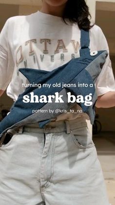 a woman is holding a shark bag in her pocket with the caption running my old jeans into a shark bag