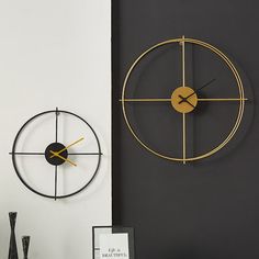 a clock that is on the wall next to a table with vases and other items