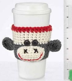 a coffee cup with a sock monkey on it