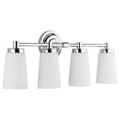 three light bathroom fixture with white shades on the side and chrome finish, in an old - fashioned style