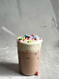 a drink with sprinkles on top and a straw in the cup