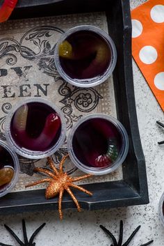 halloween drinks in plastic cups on a tray