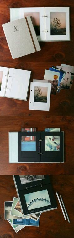 an open book sitting on top of a wooden table next to pictures and pencils