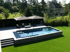 an aerial view of a backyard with a swimming pool