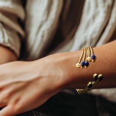 The Jahnavi Bracelet embodies the vibrant essence of the River Ganga with its luxurious blend of contrasting stones set in gold. Featuring custom-cut Lapis lazuli and ivory pearls, it creates a regal and dynamic accessory. Ivory Pearl, Household Chores, Independent Designers Fashion, Stone Settings, Jewelry Plate, The River, Lapis Lazuli, Deodorant, Mother Of Pearl