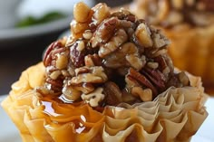 there is a cupcake with nuts in it on the plate next to another cupcake