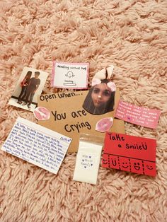 a pile of paper with pictures and words on it sitting on top of a carpet