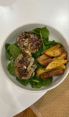 a white bowl filled with food on top of a table