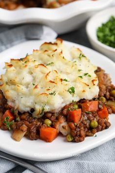 a white plate topped with mashed potatoes and meat