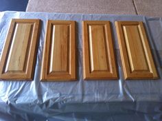 four wooden cabinet doors sitting on top of a table