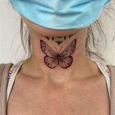 a woman's neck with a butterfly tattoo on her left side ribcage