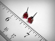 Classic birthstone earrings, simulated red ruby earrings. Set in solid 14K yellow or white gold. The imitation rubies are a beautiful, bright red, with even just a bit more sparkle and better clarity than genuine rubies themselves. Ideal as the July birthstone. Measuring 4.0mm in diameter. Also available in 5.0mm, 6.0mm, 7.0mm. The 14K gold mountings and backs are of solid cast mounts, die struck, and will give a lifetime of enjoyment. Ships in 1 to 2 business days. Gift boxed. Red Prong Set Earrings For Valentine's Day, Red Prong-set Earrings For Valentine's Day, Valentine's Day Red Earrings With Prong Setting, Ruby Gemstone Earrings As Gift, Round Lab-created Ruby Earrings For Gift, Lab-created Ruby Gemstone Earrings As Gift, Lab-created Ruby Gemstone Earrings For Gift, Lab-created Ruby Earrings For Gift, Red Birthstone Earrings For Anniversary