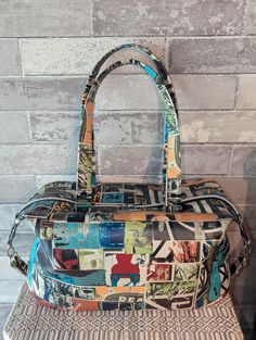 This is a one-of-a-kind large Industrial print unique Brooklyn Traveler bag. The hardware is in silver. The vinyl material that I used is an upholstery material and will hold up very very well .  There is an interior zip pocket as well as an interior slip pocket. both are trimmed with vinyl. The lining is black cotton. This purse also has purse feet.  Please message me if you have any questions. Including the straps, the total height is 19 inches high. This purse is 15 inches wide.  Front to back. the depth is 9 inches.  Purse height without including the straps is 7 inches. Retro Satchel Box Bag For Travel, Retro Top Handle Box Bag For Travel, Large Modern Box Bag With Handles, Modern Large Box Bag, Retro Travel Box Bag With Removable Pouch, Retro Travel Tote Box Bag, Modern Bags With Detachable Strap For Trip, Large Travel Box Bag, Multicolor Double Handle Box Bag For Travel