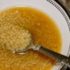 a spoon with some food in it on a plate