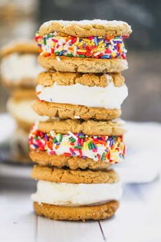 a stack of cookies covered in frosting and sprinkles on top of each other