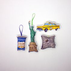 three magnets depicting the statue of liberty, new york city and taxi