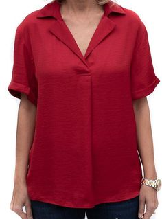 Take a look at our beautiful Ruby Red Notch Collar Short Sleeve Blouse Soft silky fabric Super soft 100% microfiber fabric Color: Ruby Red Semi loose body with short sleeves Notch collar with a pleat detail in the front Back has a yoke and decorative small buttons Center back length is 25" Elegant Short Sleeve Solid Color Blouse, Elegant Short Sleeve Blouse In Solid Color, Classic Short Sleeve Rayon Tops, Classic Short Sleeve Solid Blouse, Classic Short Sleeve Solid Color Blouse, Classic Short Sleeve Blouse, Solid Color Short Sleeve Relaxed Fit Blouse, Solid Color Short Sleeve Blouse With Relaxed Fit, Solid Color Relaxed Fit Short Sleeve Blouse