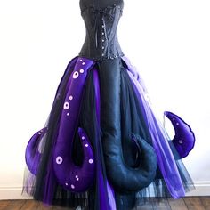 a purple and black dress with white polka dots on the bottom, along with an octopus tail