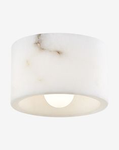 a white ceiling light with a marbled finish on the top and bottom part of it